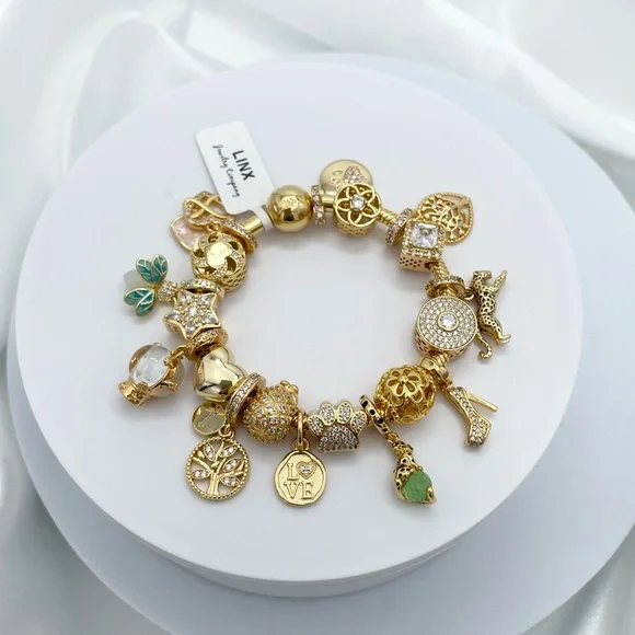 Linx Yellow Gold Bracelet with Gold and Green Themed Charms